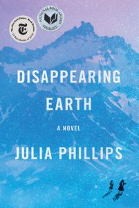 Disappearing Earth Cover Art - Two small human figures ruwalking across the snow field with a large blue mountain in the background